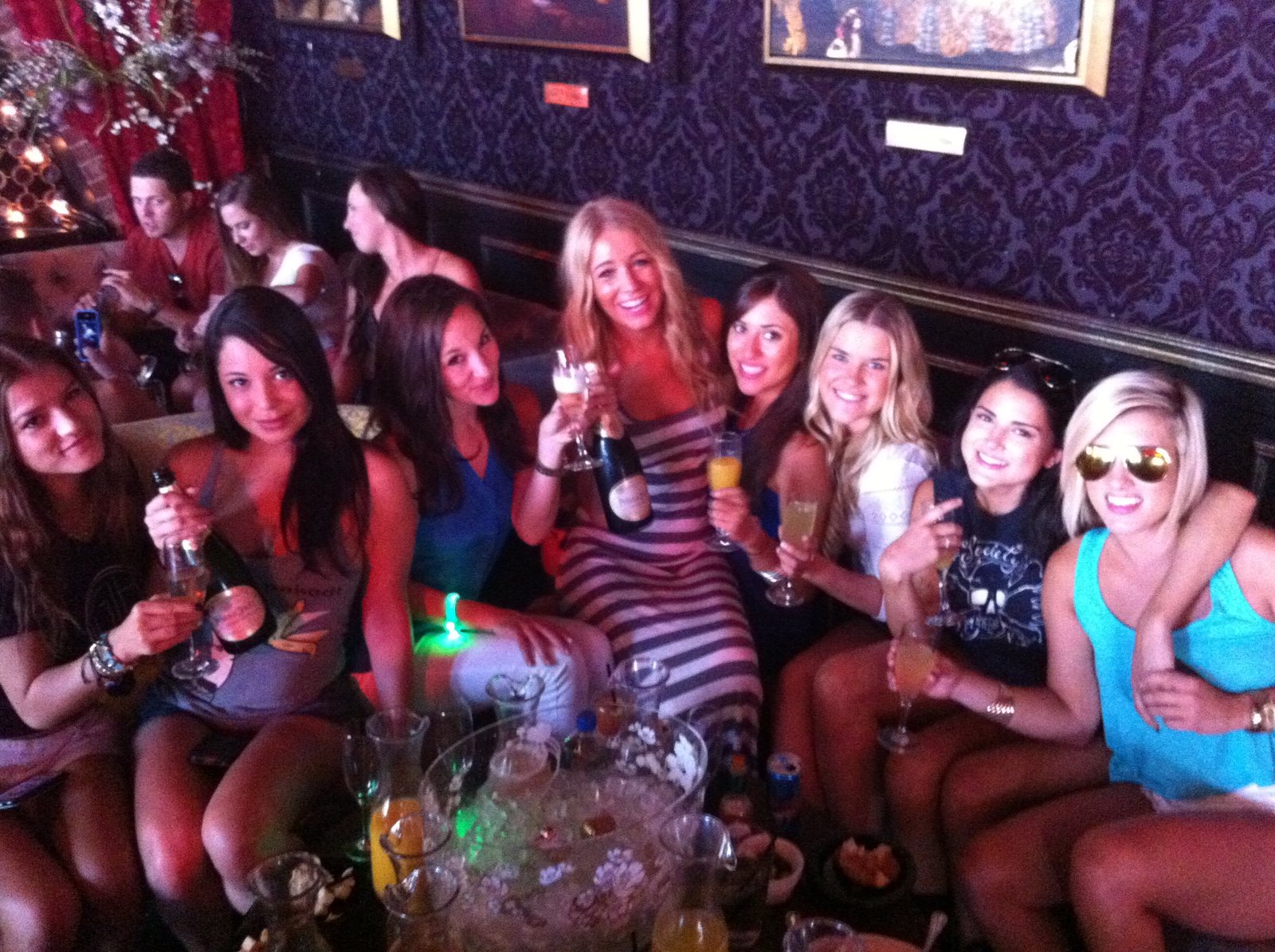A large group gathered around a decorated club booth