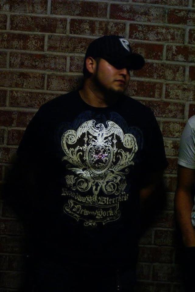 Cixx in a quiet brick-wall portrait between nightlife moments