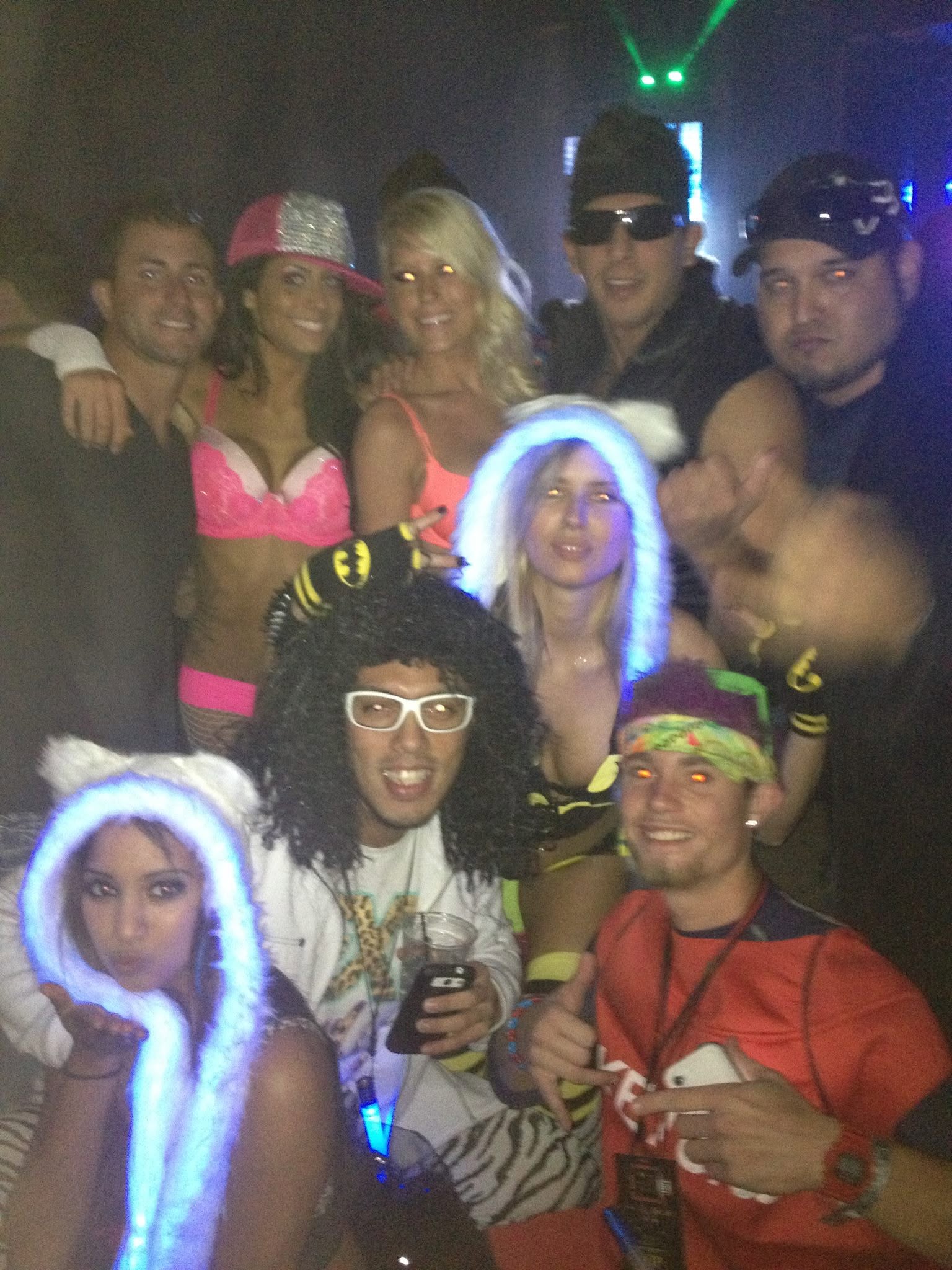 Cixx in a packed nightlife group portrait under club lights