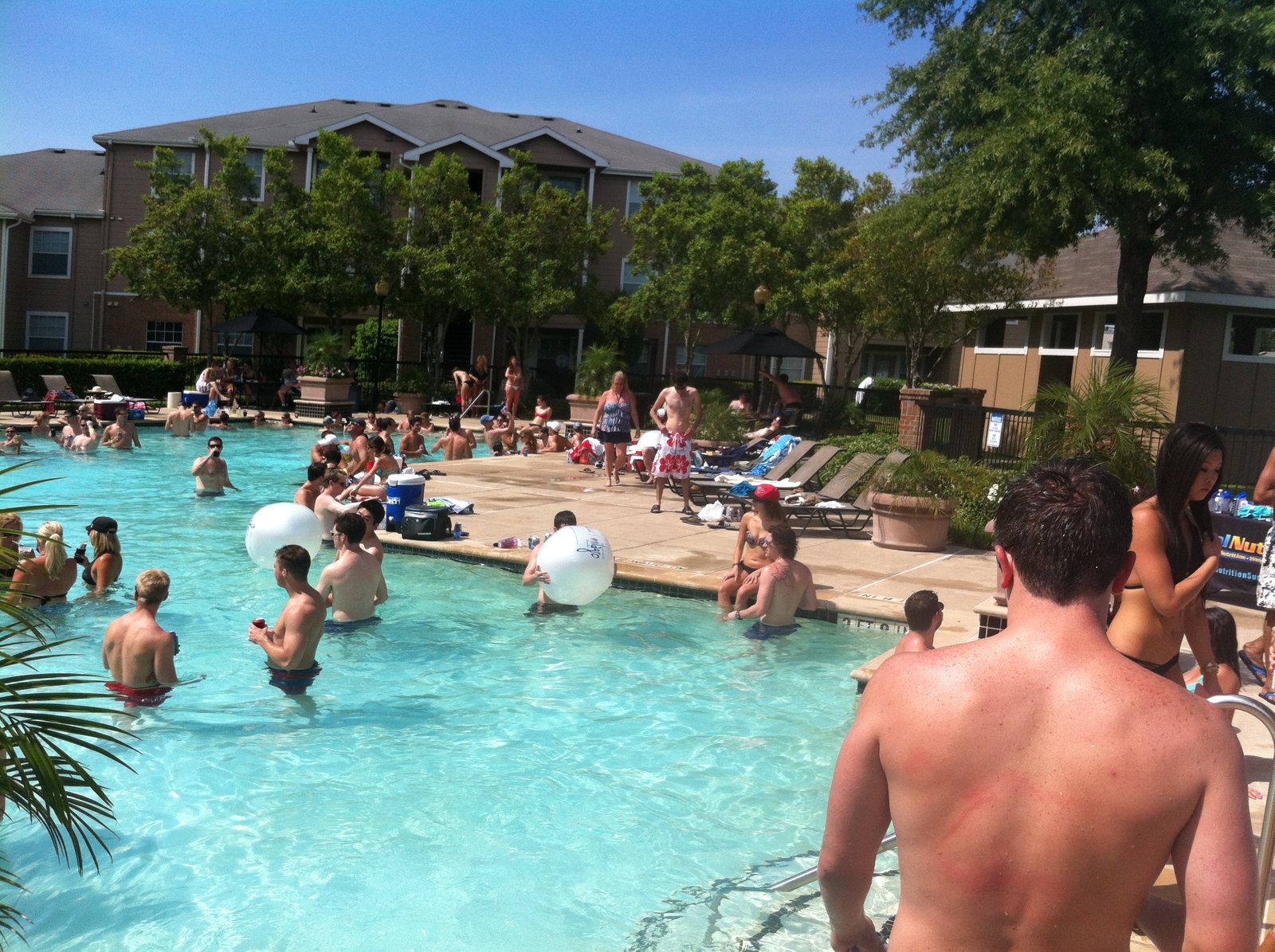 A wide view across a crowded pool party