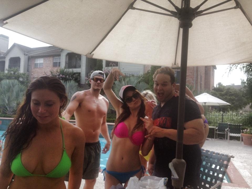 Friends gathered beneath a poolside canopy