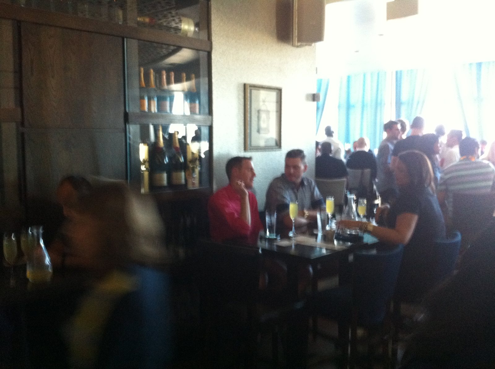 A busy nightlife room in motion around the tables