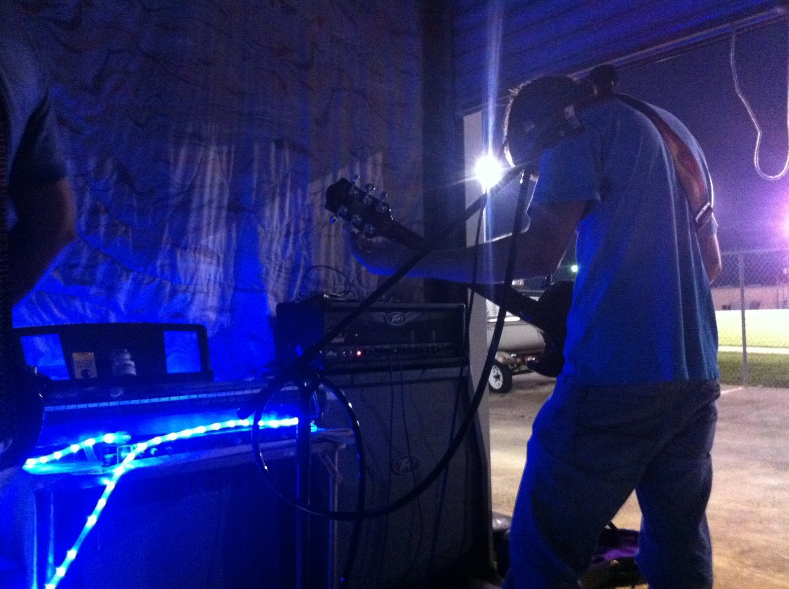 A live performance taking shape beneath blue stage light