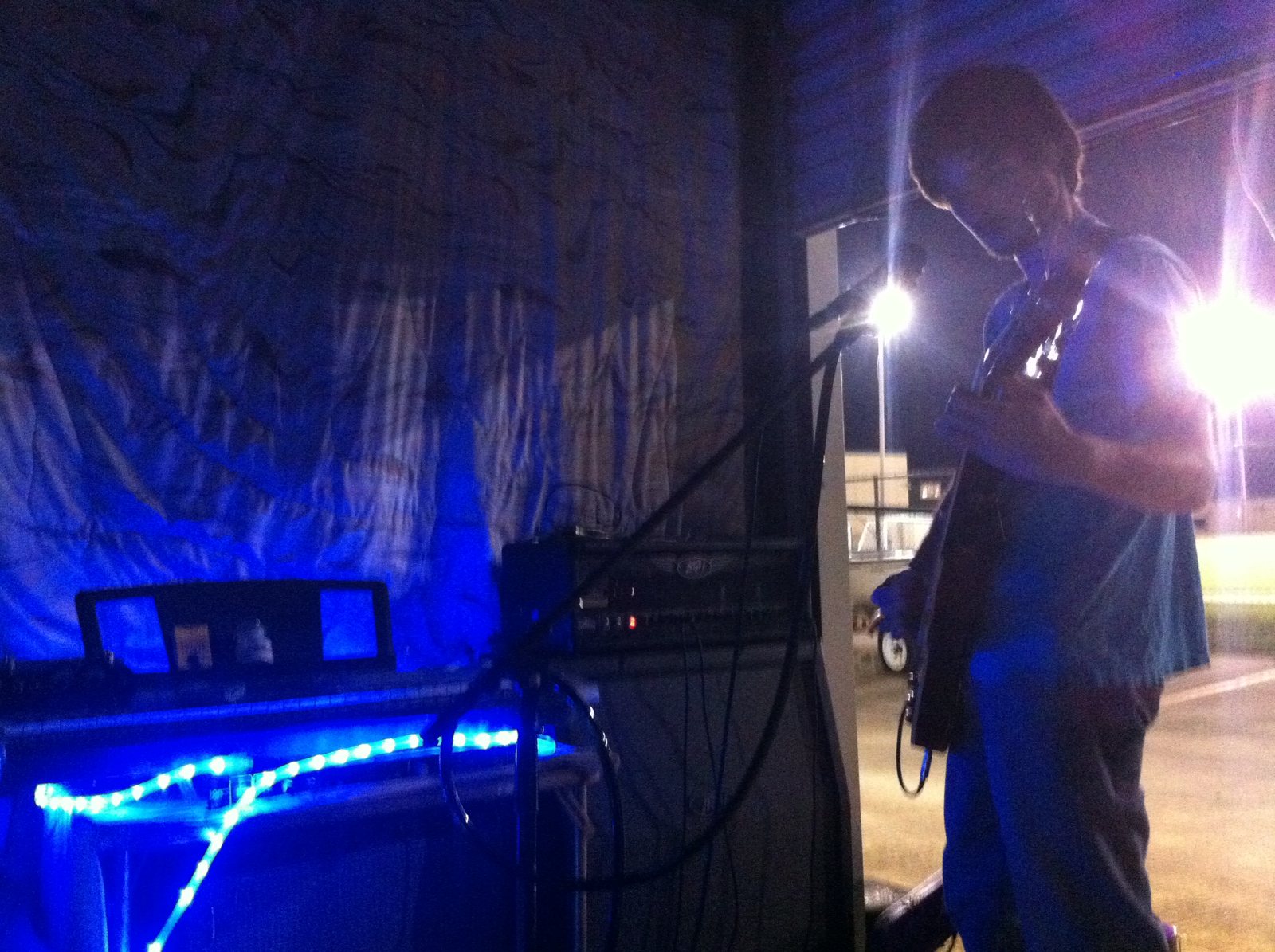 A performer at the microphone seen from stage side