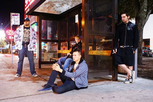 Paradigm Grey posing beside a city bus stop at night