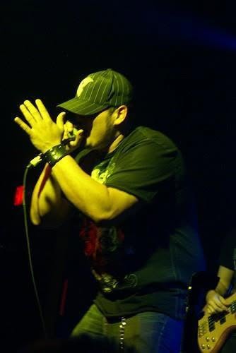 Cixx performing live at the microphone with Paradigm Grey