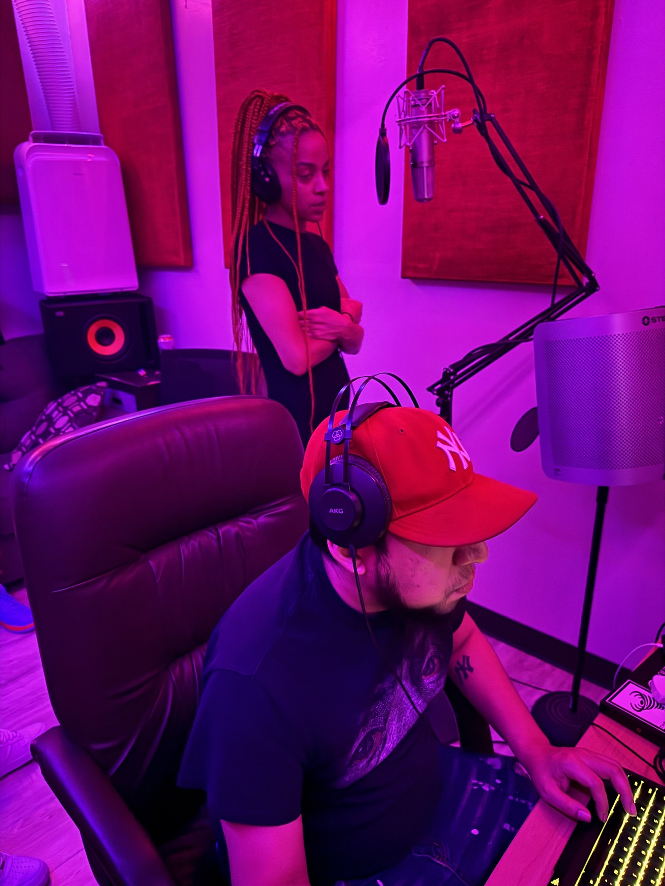 A vocalist preparing at the microphone inside THE BLENDER studio